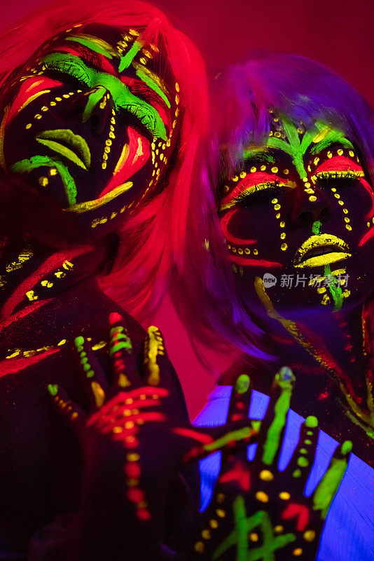 Two Young Women With Fluorescent Makeup